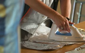 Chip packets being prepared to create foil blankets for rough sleepers.