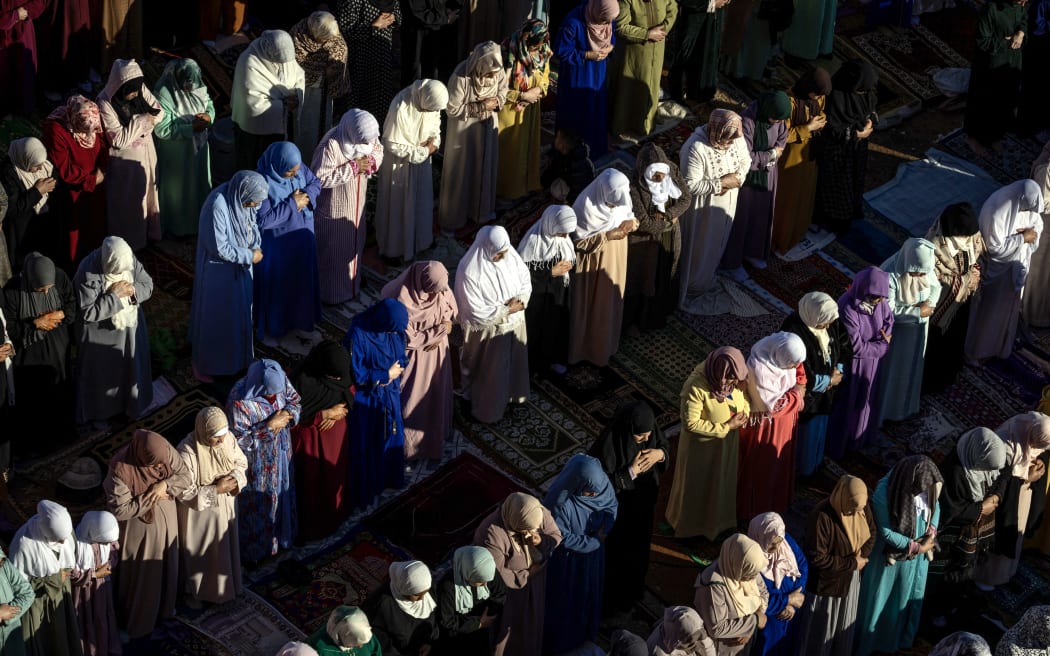 Moroccan Muslim women perform prayers for Eid al-Fitr which marks the end of Islam's holy fasting month of Ramadan in the city of Sale, north of the Moroccan capital Rabat, on April 10, 2024. (Photo by FADEL SENNA / AFP)