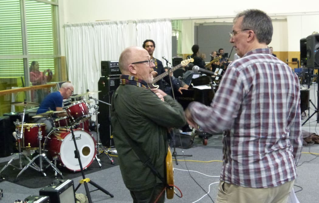 Dave Dobbyn (left) during rehearsal talking to music director, Mark Dorrell.