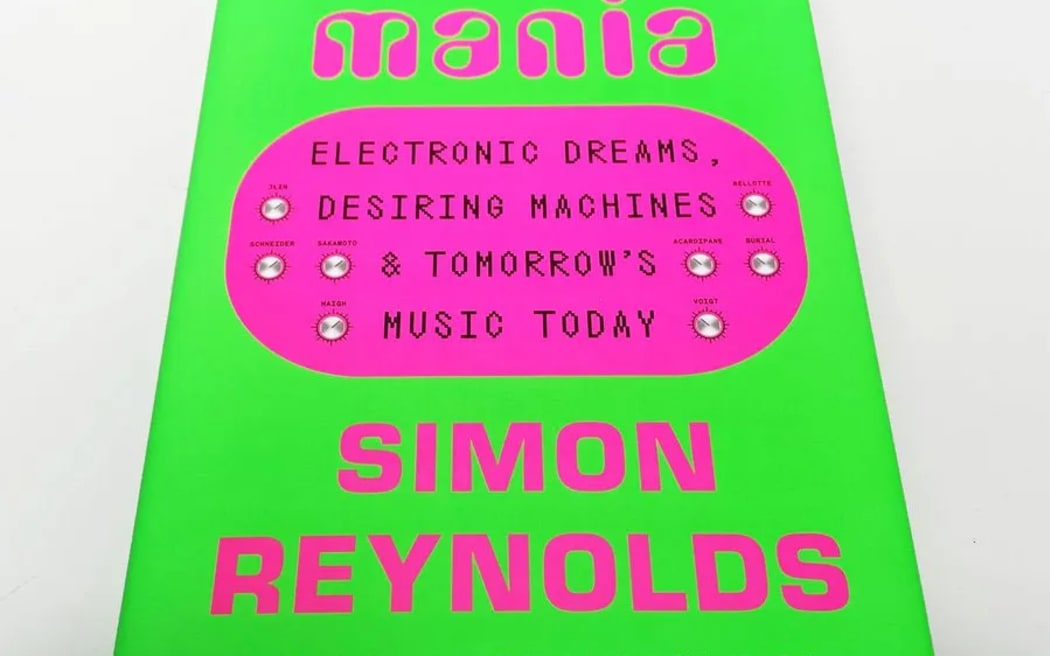 A photograph of a book. The book is called "FUTUROMANIA", and it features a bright green cover with bright pink lettering. It is written by "SIMON REYNOLDS".