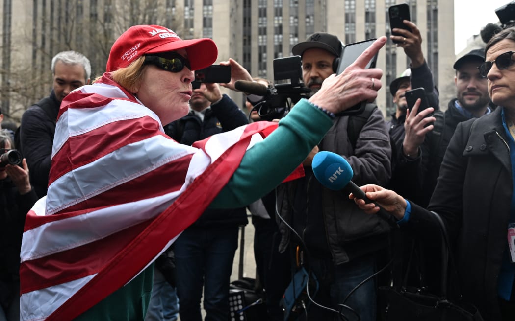 A supporter of former US President Donald Trump berates members of the press outside the District Attorneys office in New York on 4 April, 2023.