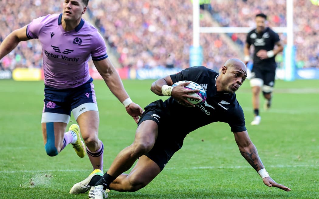 All Blacks winger Mark Telea scores against Scotland at Murrayfield.