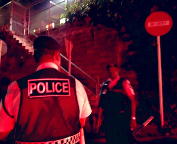 Fiji police officers standing outside the Criminal Investigations Department in Toorak where Sitiveni Rabuka was taken for questioning. 16 December 2022