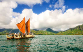 The day breaks over HÅkÅ«leÊ»a with Kualoa behind her.