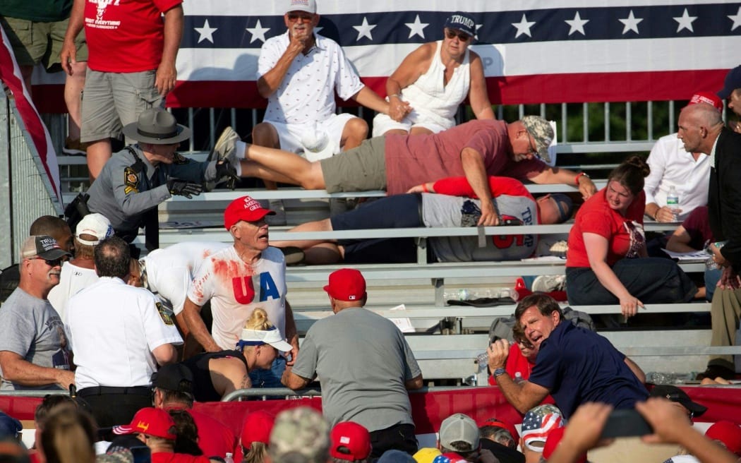 Trump supporters are seen in the stands after shots were fired at a campaign rally for Donald Trump in Butler, Pennsylvania, 13 July, 2024.
