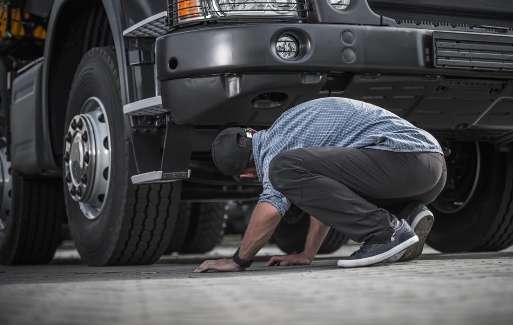 Stock image of someone inspecting a truck.