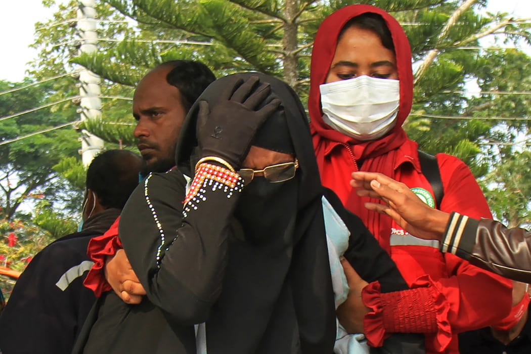 A woman weeps after looking at the body of her relative who died on a ferry after it caught fire killing and injuring scores of people at Jhalkathi, Bangladesh.
