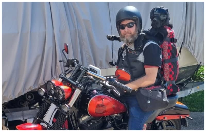 Stevin Creegan gets on his Harley Davison with his best mate Loki.