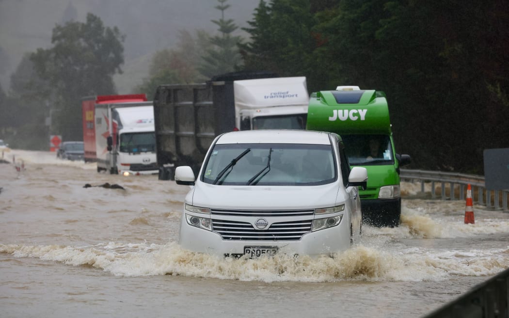 Motorists negotiate SH1 floodwaters north of Whangārei on Thursday.