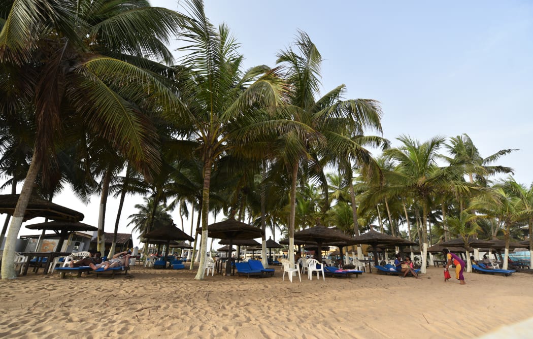 A file photo shows locals relaxing on the beach at Grand Bassam, Ivory Coast, in April 2015.