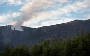 Smoke and helicopters can be seen in the sky from Hoon Hay Valley Road.