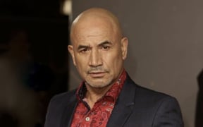 New Zealand actor Temuera Morrison in a red shirt and black jacket