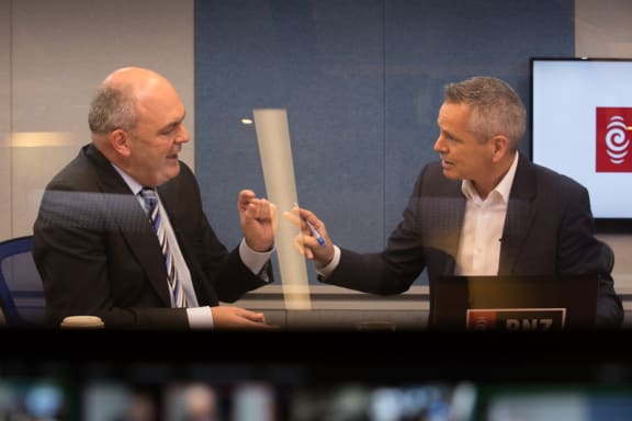 National's Steven Joyce, left, RNZ host Guyon Espiner, right, in Morning Report's Auckland studio.