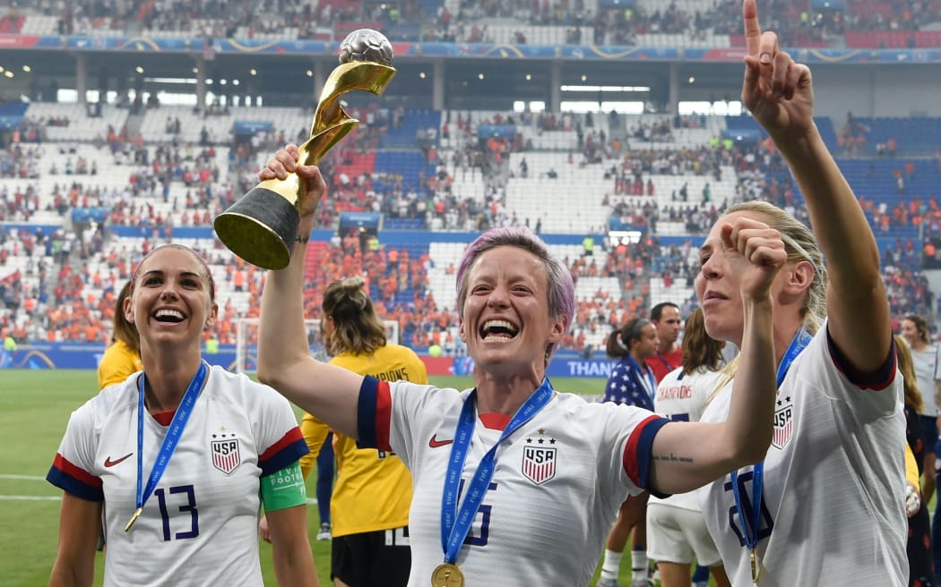 USA's players including forward Megan Rapinoe (C) celebrate with the trophy after the France 2019 Women's World Cup football final match between USA and the Netherlands, on July 7, 2019.