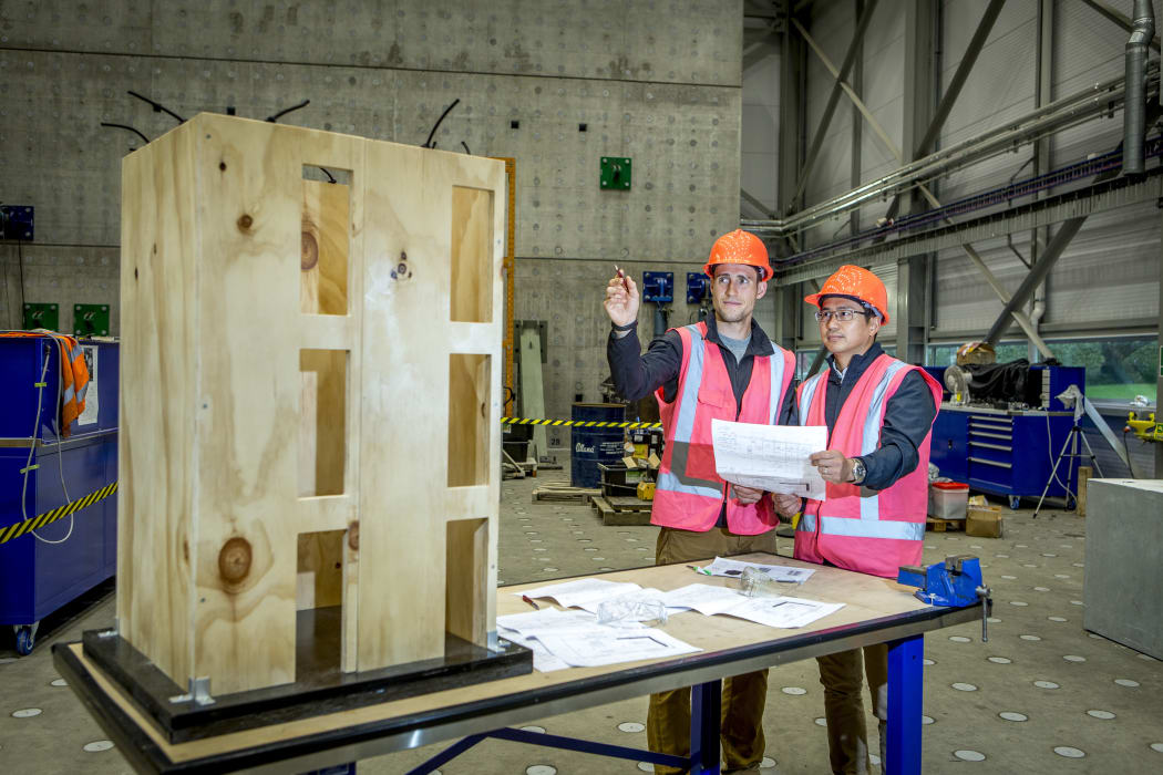 Civil Engineering, researcher Justin Brown and supervisor Minghao Li photographed with thier construction model in the Structural Engineering Lab.