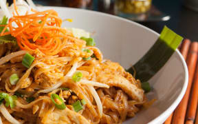 Chicken pad Thai dish of stir fried rice noodles with a contemporary presentation.