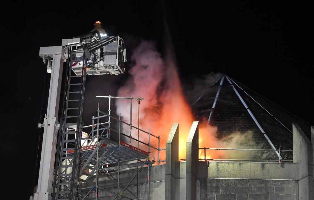 Firefighters prepare to tackle the fire blazing in the St Paul's Cathedral roof at 3.30am on Tuesday.