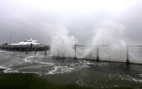 Water breaks onto Tamaki Drive in Auckland as Cyclone Tam brings heavy wind and rain.