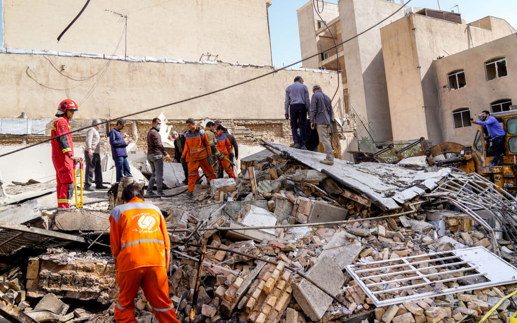 In this picture obtained from Iran's ISNA news agency, rescuers search through the rubble of a collapsed building at the site of a strike on a neighborhood, in Tehran on February 28, 2026. The United States and Israel launched strikes against Iran on February 28, with Israel's public broadcaster reporting that supreme leader Ayatollah Ali Khamenei had been targeted, as the Islamic republic retaliated with barrages of missiles at Gulf states and Israel. (Photo by AMIR KHOLOUSI / ISNA / AFP)