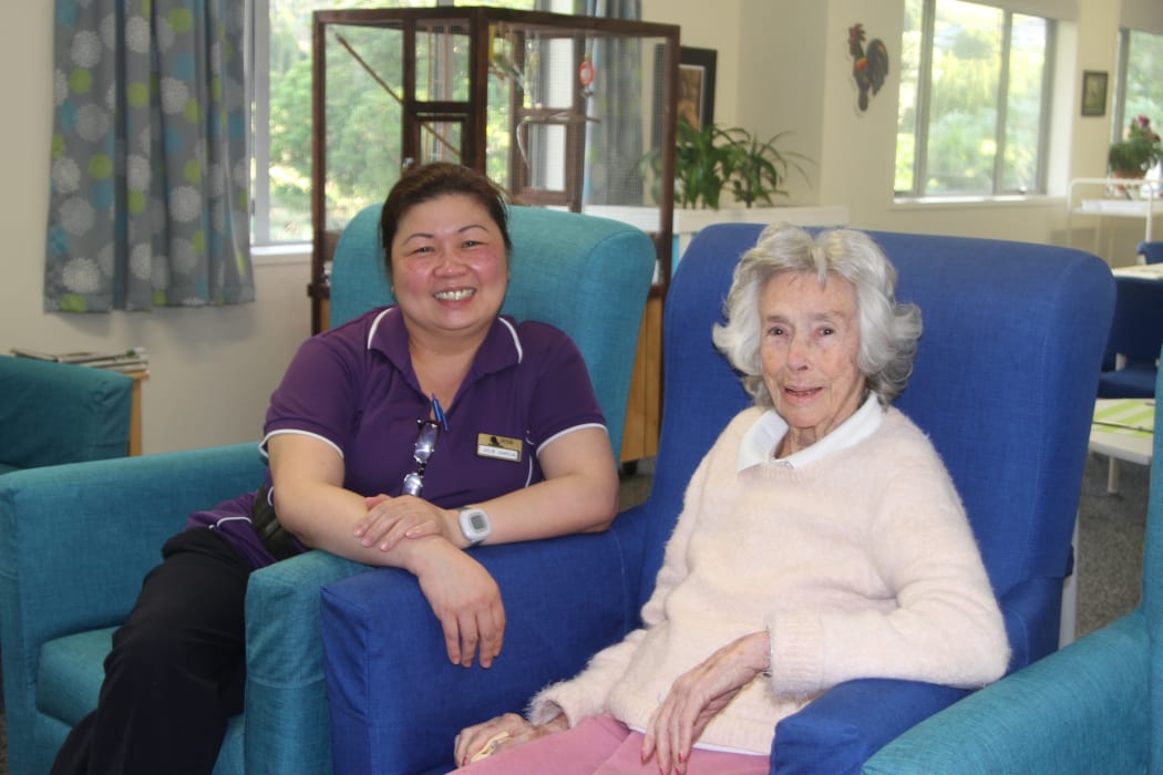 Juliet Garcia doing the job she loves, with Switzer resident Kathleen Bowater.