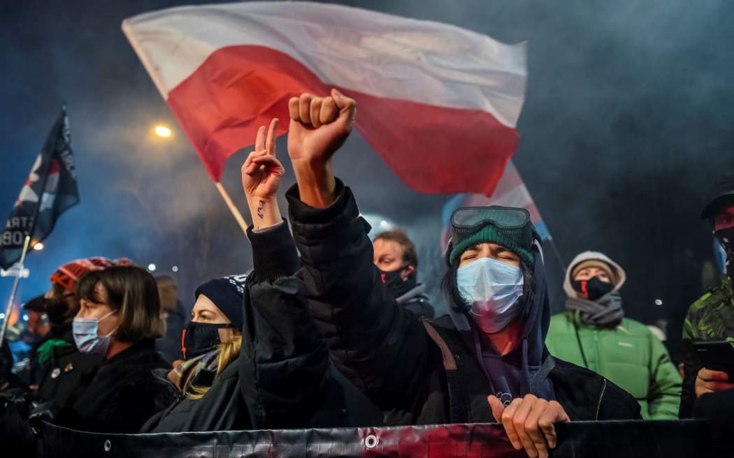 A demonstrator gestures as people take part in a pro-choice protest in the center of Warsaw, on January 27, 2021, as part of a nationwide wave of protests since October 22, 2020 against Poland's near-total ban on abortion.