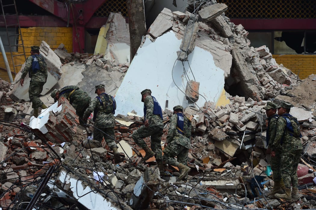 Rescuers search through rubble in Juchitan