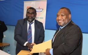 PNG's prime minister James Marape (right) shakes hands with Ishmael Toroama, the president of the autonomous region of Bougainville, 5 February 2021.