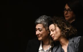 Visitors react after the parliamentary vote on same-sex marriage in Athens, on 15 February, 2024.  (Photo by Angelos TZORTZINIS / AFP)