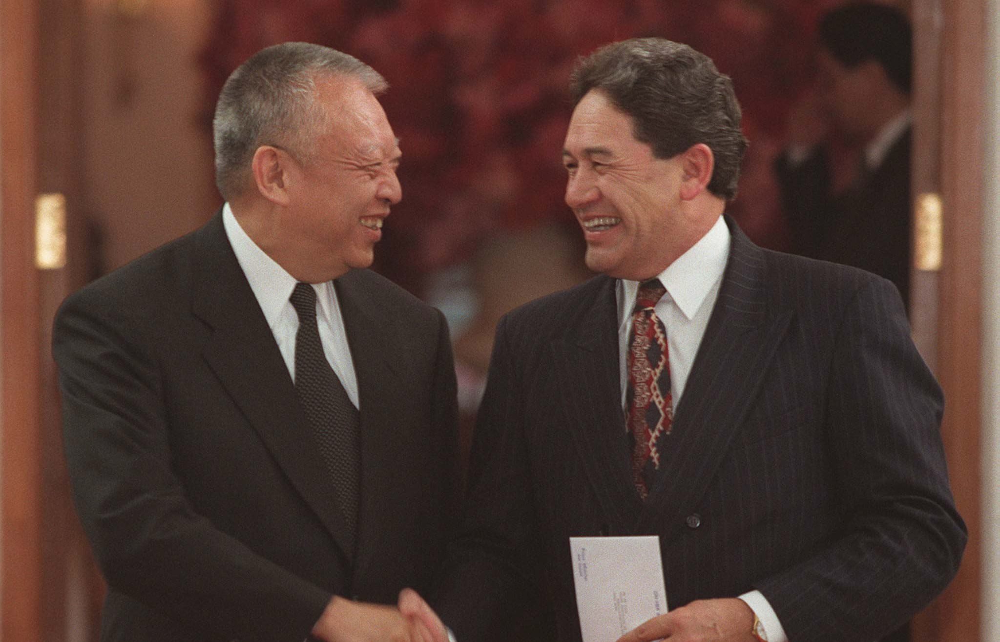 Hong Kong chief executive Tung Chee-hwa, left, and New Zealand's former Treasurer Winston Peters shake hands during their meeting at the Government House in Hong Kong 2 July, 1997.