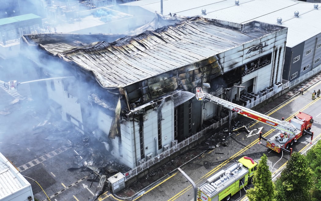 Firefighters work at the site of a burnt lithium battery manufacturing factory in Hwaseong, South Korea, Monday, June 24, 2024. (Hong Ki-wonj/Yonhap via AP)