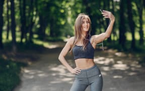 Girl exercising and taking a selfie.