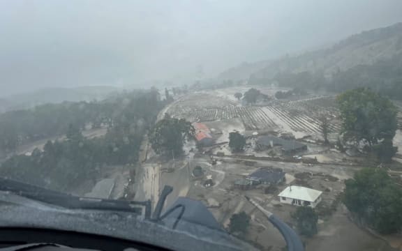An NH90 helicopter and crew recover people from the rooftops of their homes in Esk Valley, Napier.