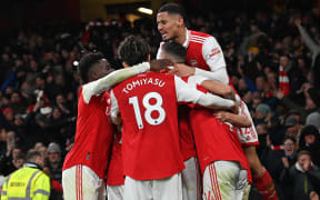 Arsenal's English striker Eddie Nketiah celebrates with teammates after scoring their third goal during the English Premier League football match between Arsenal and Manchester United at the Emirates Stadium in London on January 22, 2023. (Photo by Glyn KIRK / AFP) / RESTRICTED TO EDITORIAL USE. No use with unauthorized audio, video, data, fixture lists, club/league logos or 'live' services. Online in-match use limited to 120 images. An additional 40 images may be used in extra time. No video emulation. Social media in-match use limited to 120 images. An additional 40 images may be used in extra time. No use in betting publications, games or single club/league/player publications. /