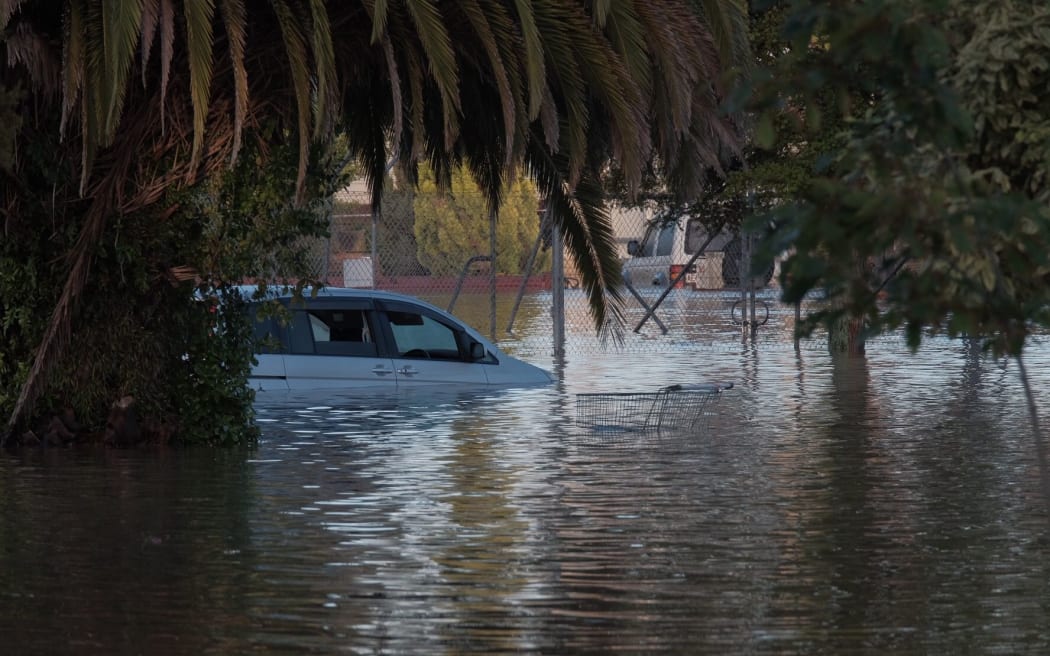 A car submerged by flooding in Edgecumbe.