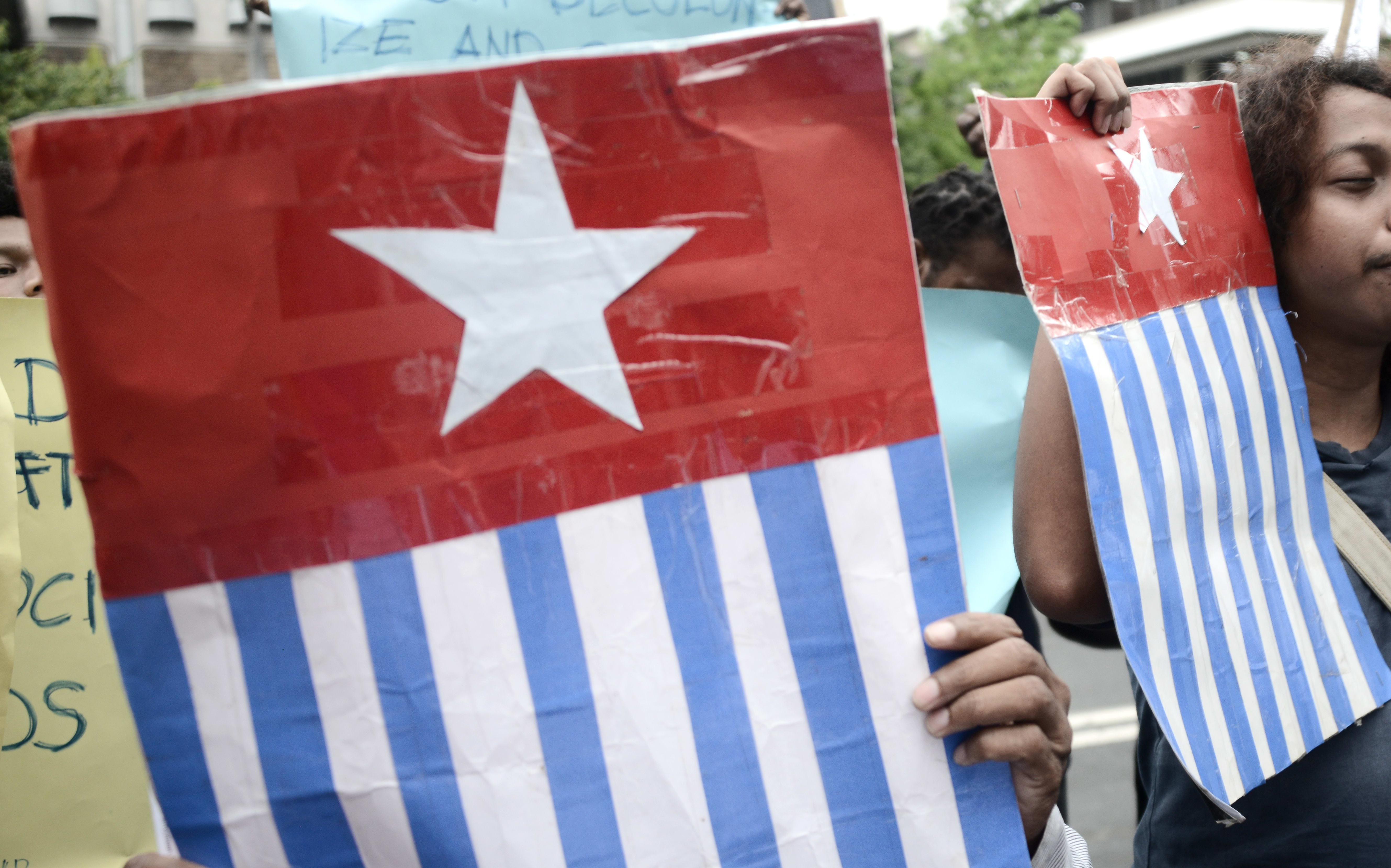 Protesters display the West Papuan pro-independence "Morning Star" flag during a demonstration by mostly university students from Free Papua Organization and the Papua Student Alliance in Jakarta on April 3, 2017. -