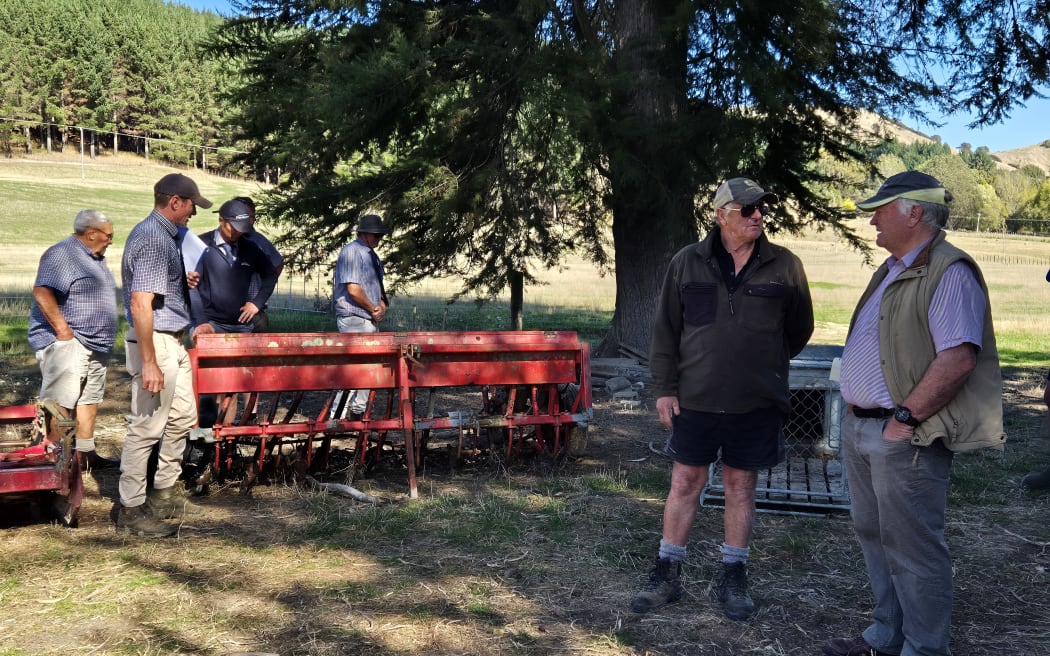 Richard Hay (right) talks to neighbour Paul Kuchenbecker (left) about one of the items for sale.