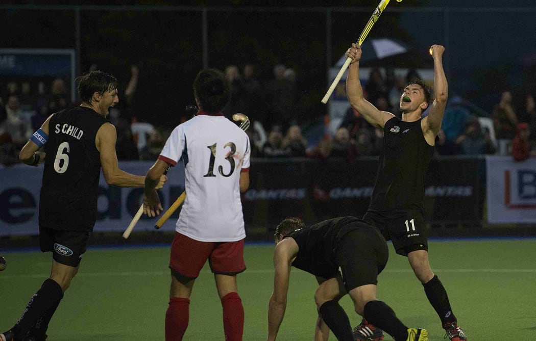 New Zealand hockey players Simon Child and Jacob Smith celebrate a goal against Japan 2014.