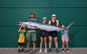 The Collins Family with the striped marlin they caught off the Kaikoura coast.