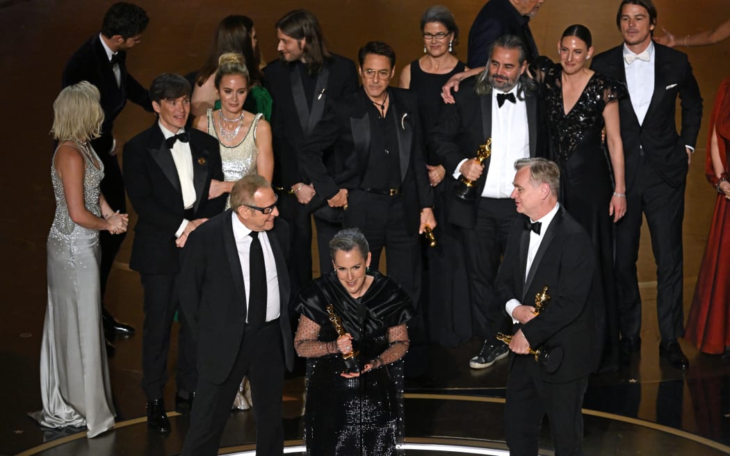 Producers of "Oppenheimer" British film producer Emma Thomas (C), US film producer Charles Roven (L) and British filmmaker Christopher Nolan accept the award for Best Picture onstage during the 96th Annual Academy Awards at the Dolby Theatre in Hollywood, California on March 10, 2024. (Photo by Patrick T. Fallon / AFP)