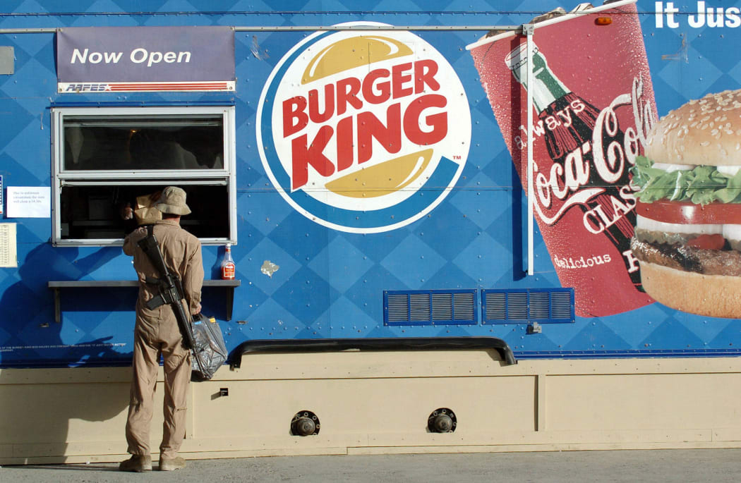 A US soldier passes an order at a Burger King shop in Bagram air base on 4 October 2004.