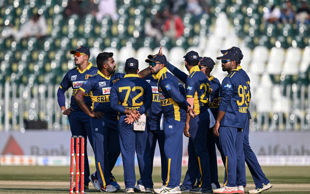 Sri Lanka's Asitha Fernando (2L) celebrates with teammates after taking the wicket of Pakistan's Saim Ayub during the first one-day international (ODI) cricket match between Pakistan and Sri Lanka at the Rawalpindi Cricket Stadium in Rawalpindi on 11 November, 2025.