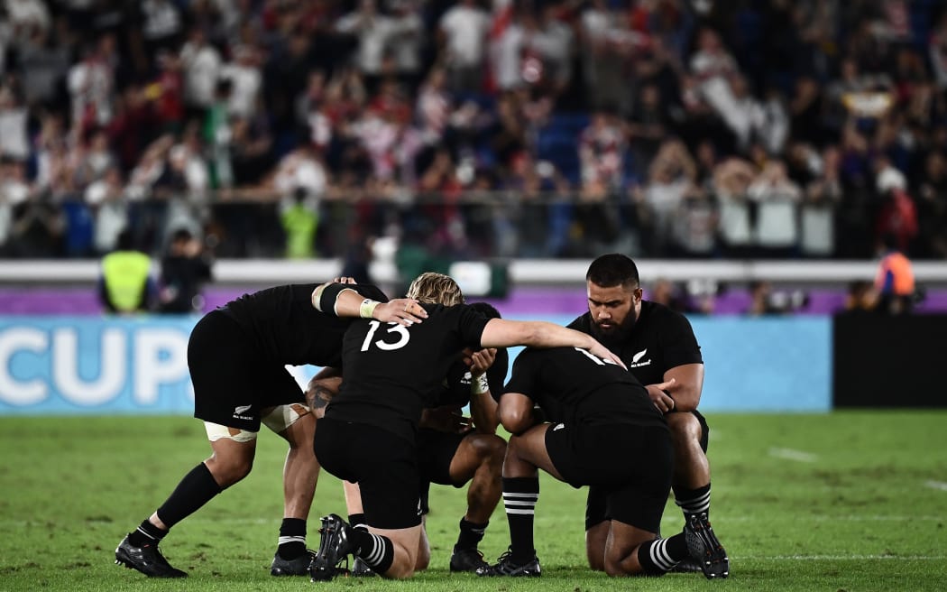 New Zealand's players react after losing the Japan 2019 Rugby World Cup semi-final match between England and New Zealand at the International Stadium Yokohama in Yokohama on October 26, 2019. (Photo by Anne-Christine POUJOULAT / AFP)