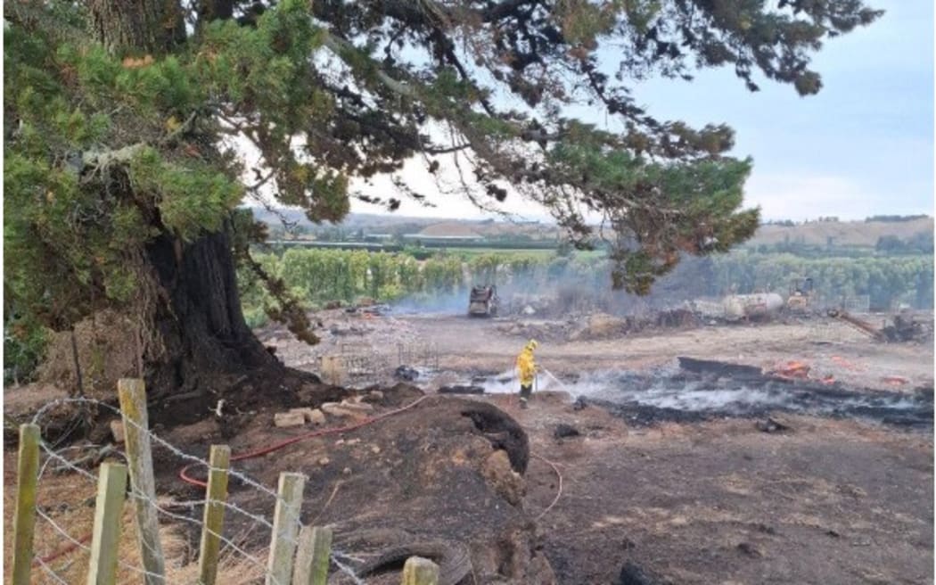 A firefighter extinguishing hotspots at the Fernhill fire on Tuesday.