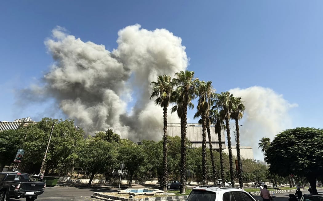 Smoke billows following Israeli strikes near the Syrian army and defence ministry headquarters in Damascus on July 16, 2025. (Photo by Rami al SAYED / AFP)