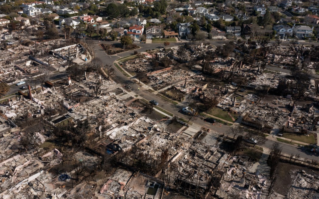 An aerial image shows homes damaged and destroyed by the Palisades Fire in the Pacific Palisades neighborhood of Los Angeles, California, on 29 January.