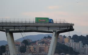 A lorry stands on the edge of the collapsed Morandi motorway bridge in the northwestern city of Genoa on August 14, 2018.
