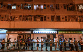 People queue to cast their vote during the district council elections in Tseung Kwan O district in Hong Kong on November 24, 2019.