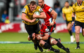 Hurricanes prop Toby Smith is tackled by Crusaders loose forward Matt Todd during the 2018 Super rugby final.
