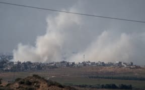 11/15/2023 Beeri, Israel. In this photograph taken near the Israeli border with the Gaza Strip a large plume of smoke rises over over Beit Hanoun in Northern Gaza after an Israeli air strike is seen, on November 16, 2023 from Sedorot, Israel. More than a month after Hamas's Oct. 7 attacks, the country's military has continued its sustained bombardment of the Gaza Strip and launched a ground invasion to vanquish the militant group that governs the Palestinian territory. (Photo by Dima Vazinovich / Middle East Images / Middle East Images via AFP)