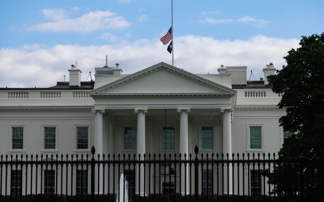 The American flag is seen at half-staff on the roof of the White House in Washington, D.C. on September 8, 2022, after news of the death of Queen Elizabeth II.